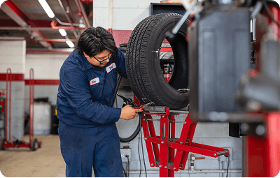 Belle Tire technician performing tire service and repair